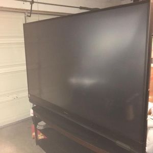 82 inch black Mitsubishi television with tv stand